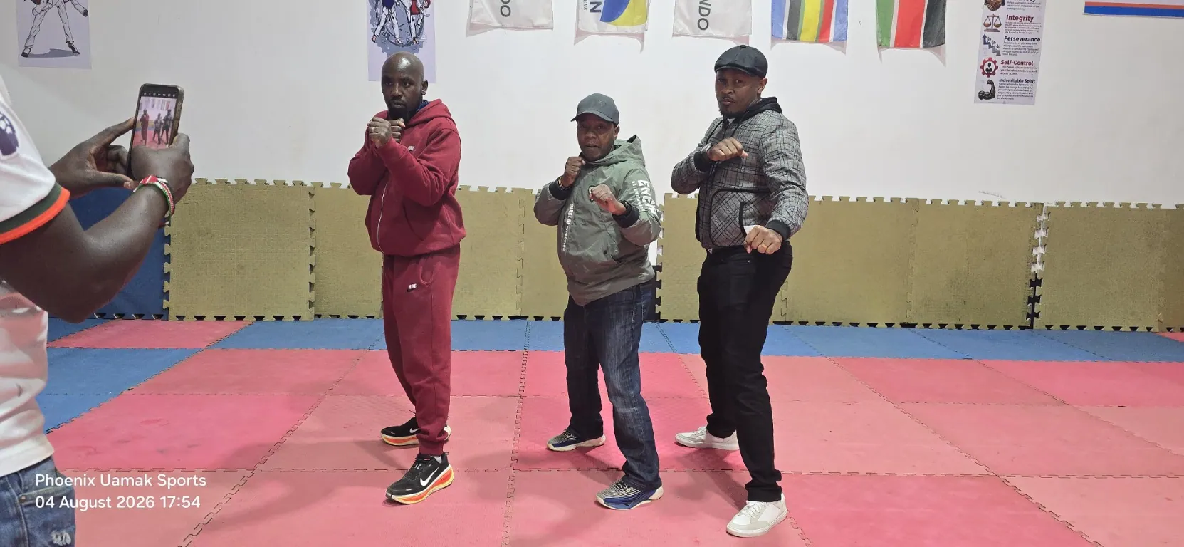 Three coaches posing on the taekwondo mats