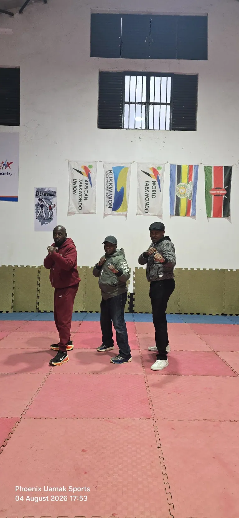 Taekwondo coaches standing together in the training hall